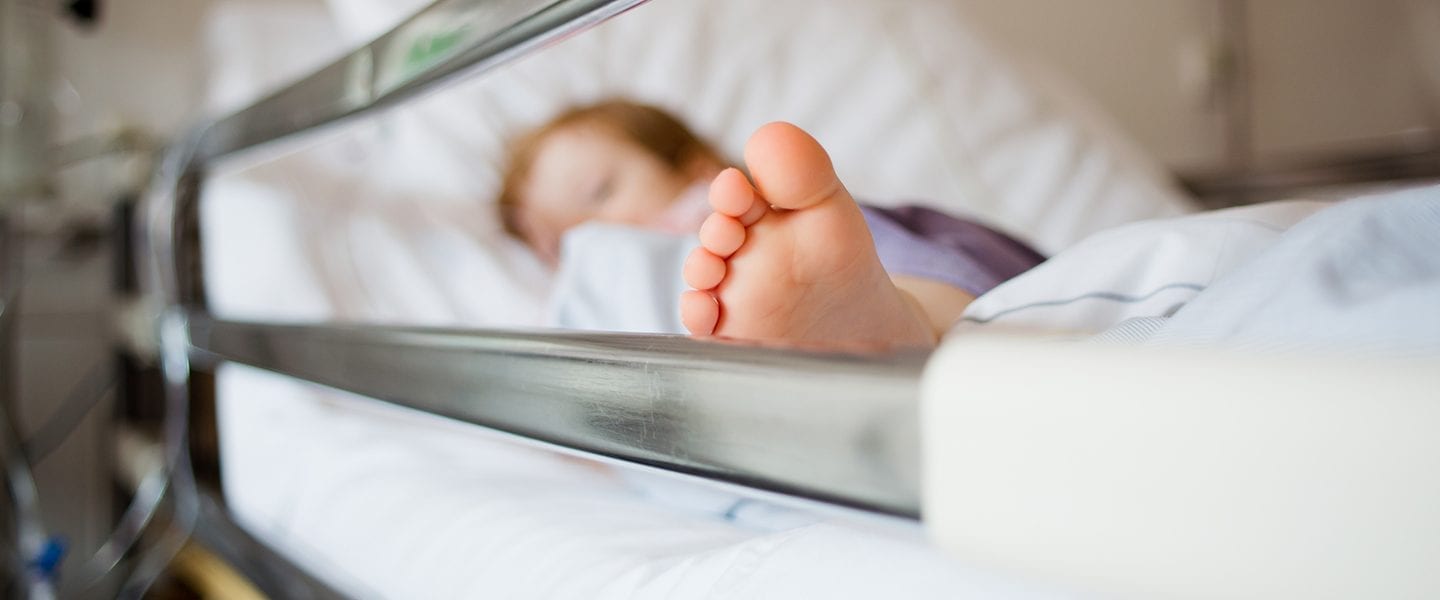 Young girl is lying in a hospital bed