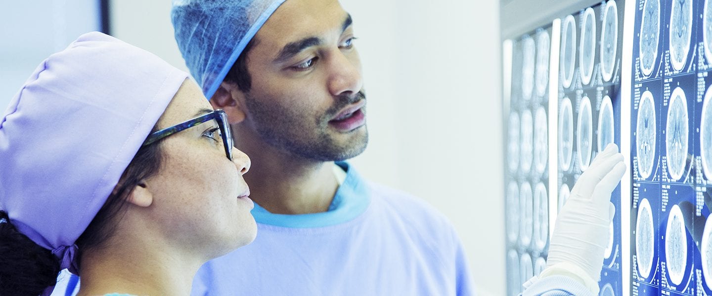 Surgeons reviewing and discussing MRI scans