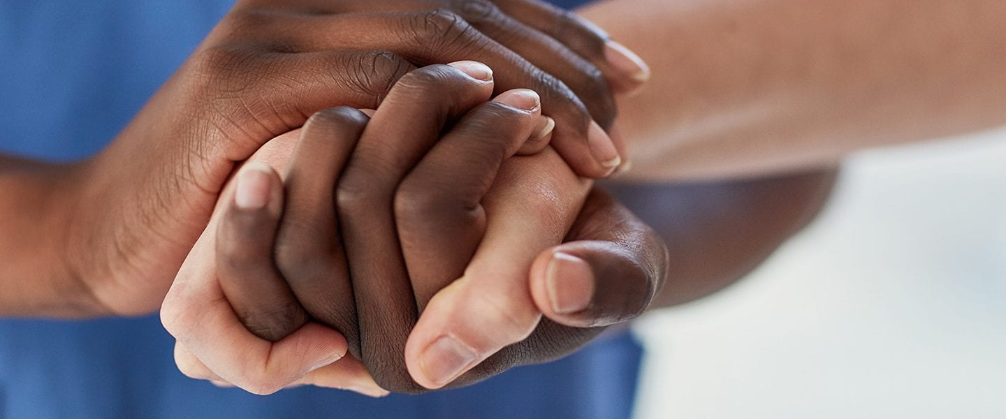 Closeup shot of a medical practitioner holding a patient's hand in comfort