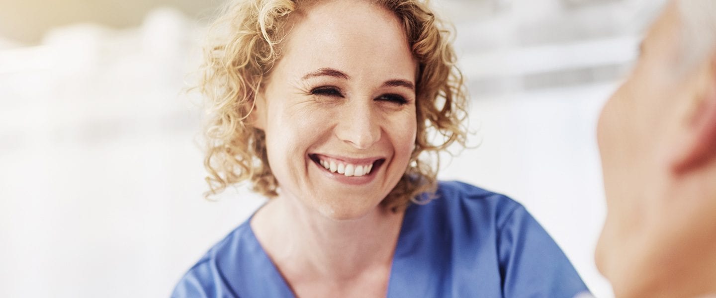Shot of a female carer talking to her recovering male patient