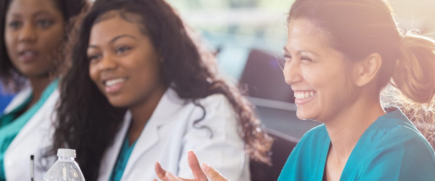 Professional development Q&A with Health care workers smile in a classroom setting