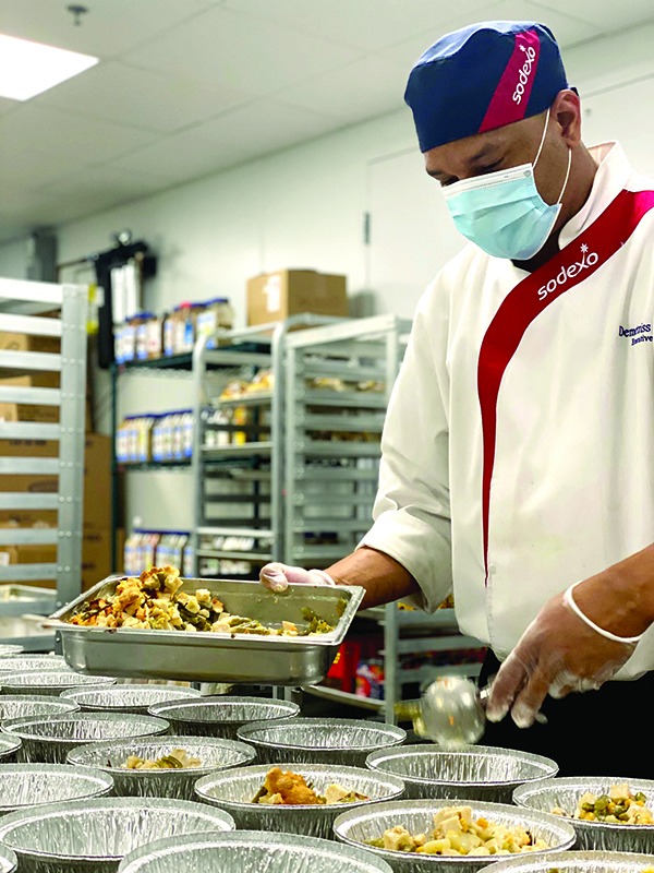 Sodexo employee preparing meals.