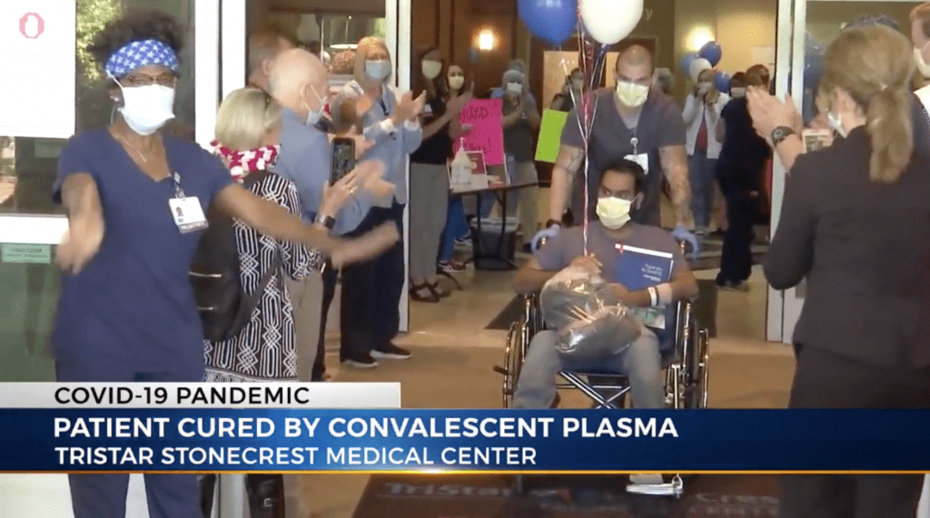 Patient leaving hospital after recovering from COVID-19 with help from convalescent plasma.